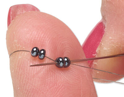 Four beads on thread and needle